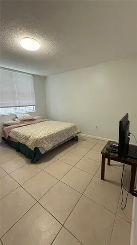 a bedroom with a bed and a desk in it