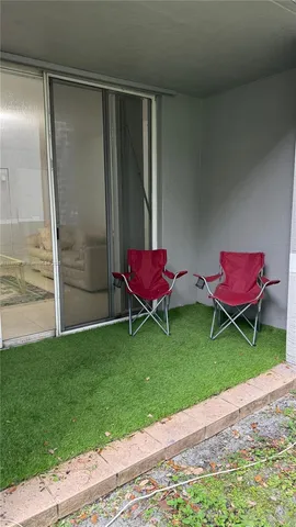 a backyard with a table and chairs