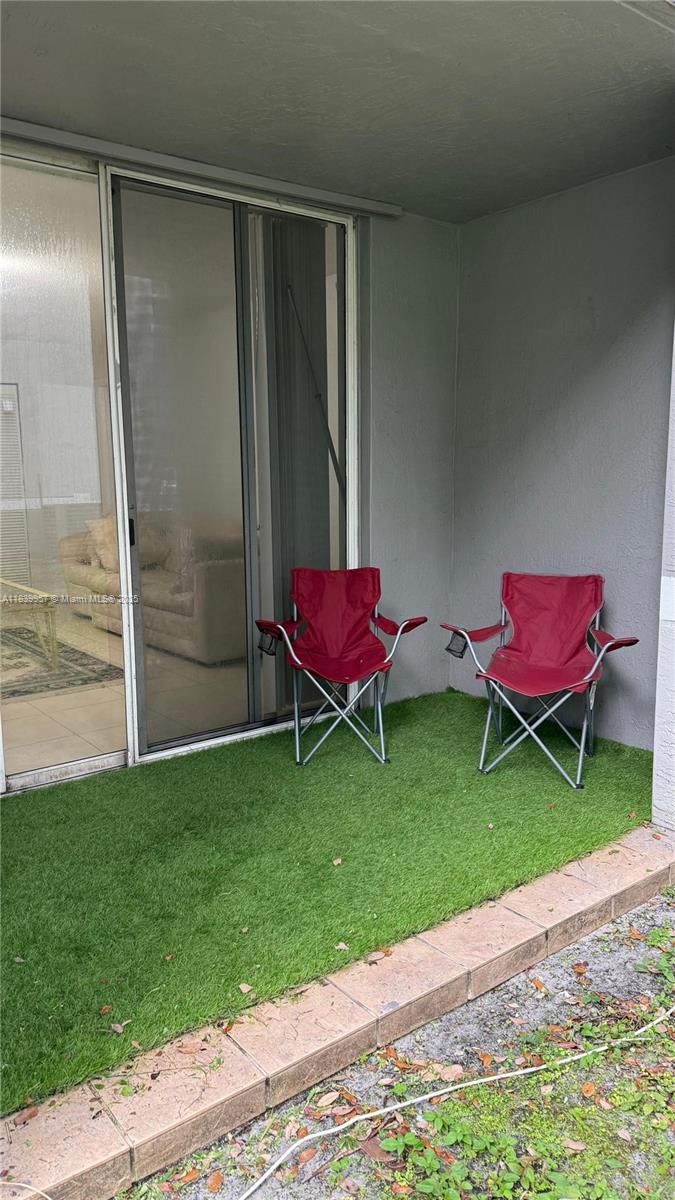 11133 Southwest 8th Street, Unit 102 Pembroke Pines, FL 33025 - Photo 29 of 35 a backyard with a table and chairs