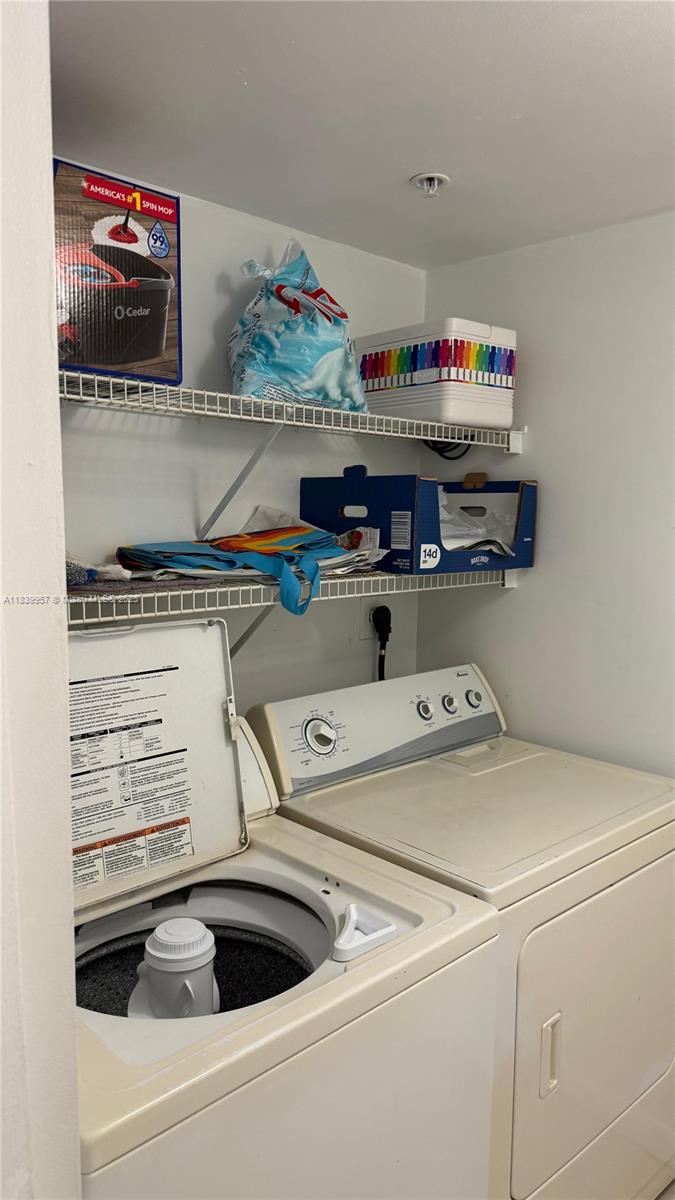 11133 Southwest 8th Street, Unit 102 Pembroke Pines, FL 33025 - Photo 32 of 35 a utility room with dryer and washer