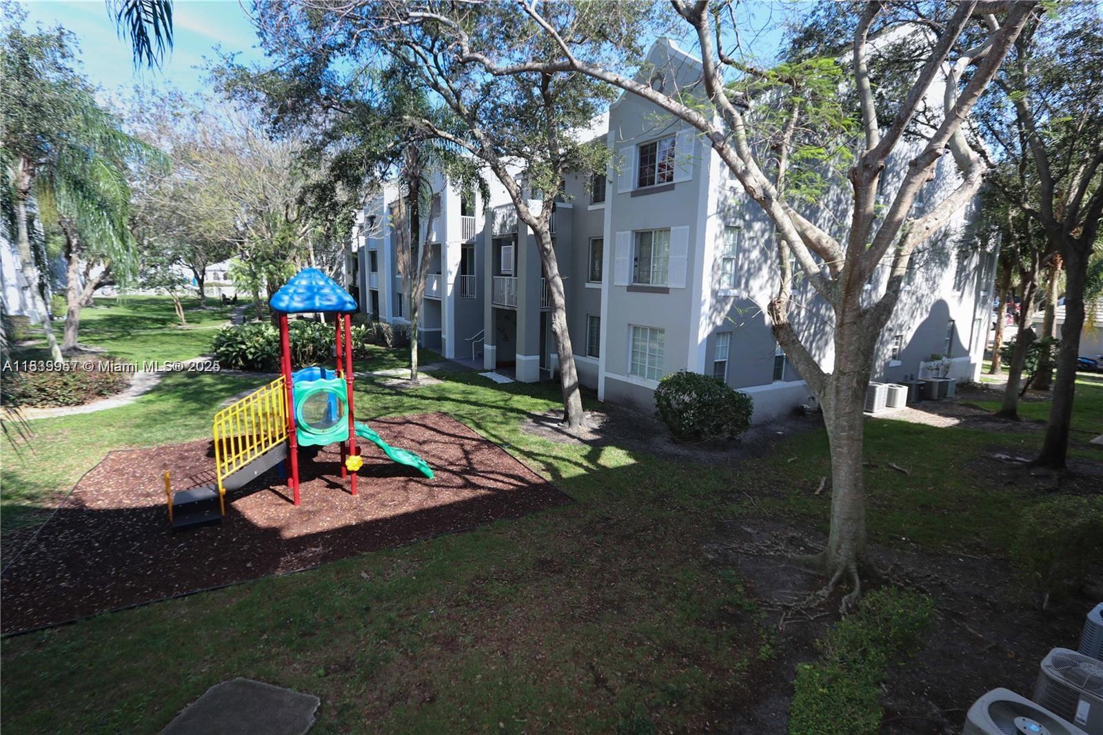 11133 Southwest 8th Street, Unit 102 Pembroke Pines, FL 33025 - Photo 4 of 35 a view of a park with large tree