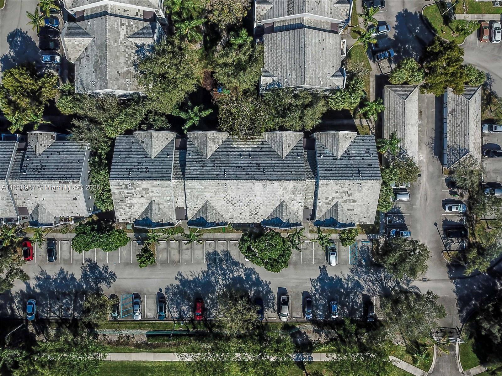 11133 Southwest 8th Street, Unit 102 Pembroke Pines, FL 33025 - Photo 5 of 35 an aerial view of a house with a yard and a large building