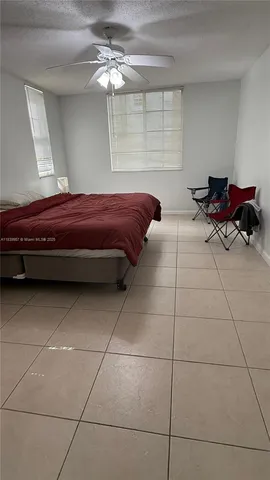 a room with a bed and a chandelier