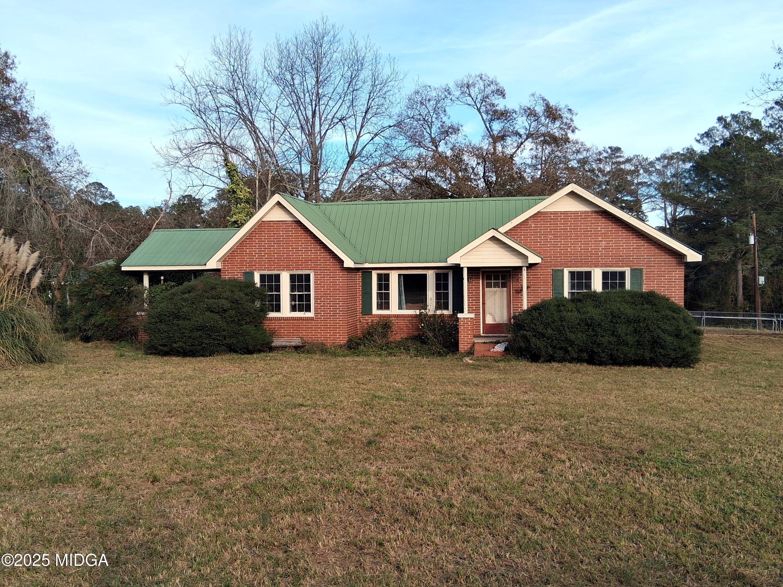 152 North Main Street Gordon, GA 31031 - Photo 1 of 37 a front view of a house with a yard and trees