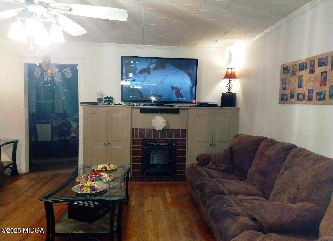 152 North Main Street Gordon, GA 31031 - Photo 11 of 37 a living room with furniture a fireplace and a flat screen tv