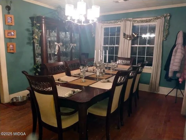 a view of a dining room with furniture window and wooden floor