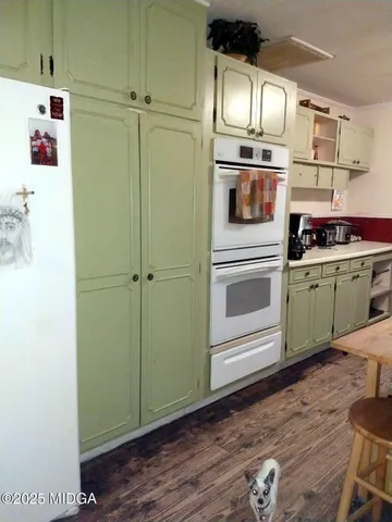 a kitchen with a refrigerator and cabinets