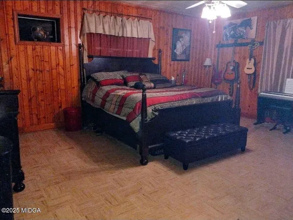 a bedroom with a bed and a television