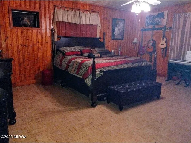 a bedroom with a bed and a television