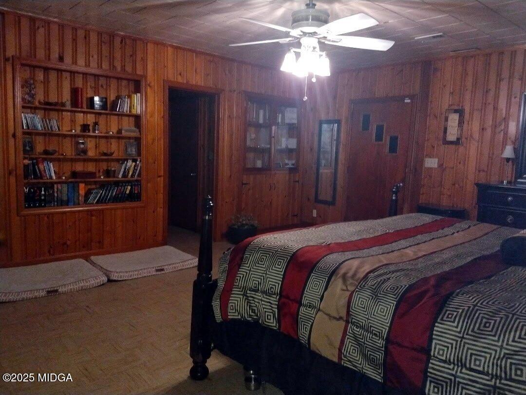 152 North Main Street Gordon, GA 31031 - Photo 23 of 37 a bedroom with a bed and a chandelier