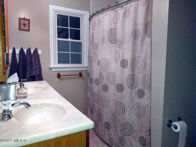 a bathroom with a sink and a window