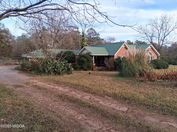 a view of a house with a yard and sitting area
