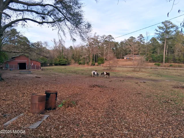 a view of a outdoor space with green field and trees