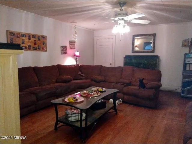 a living room with furniture a bed and a chandelier