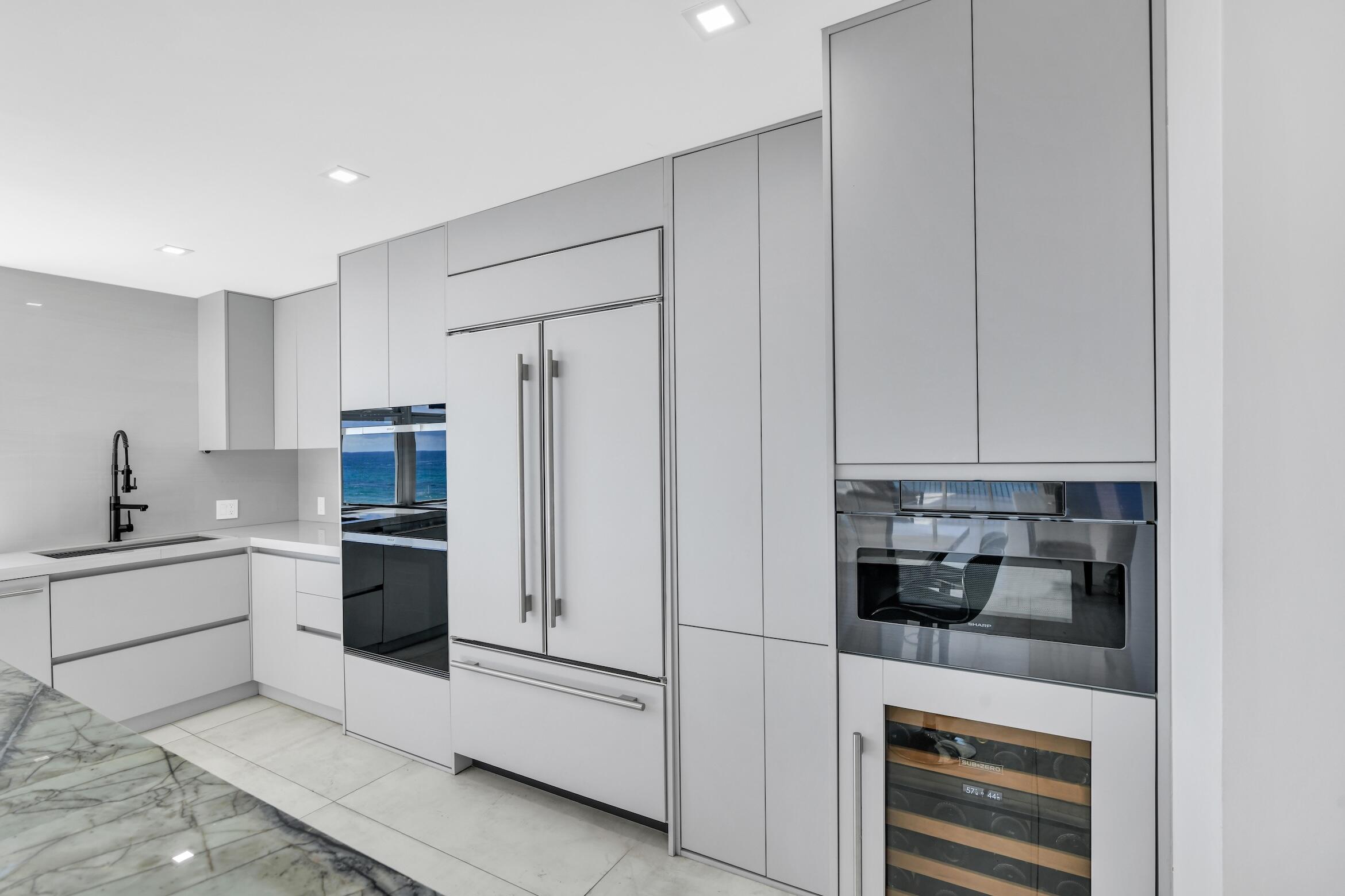 2000 South Ocean Boulevard, Unit 6K Boca Raton, FL 33432 - Photo 18 of 93 a kitchen with stainless steel appliances white cabinets and a refrigerator