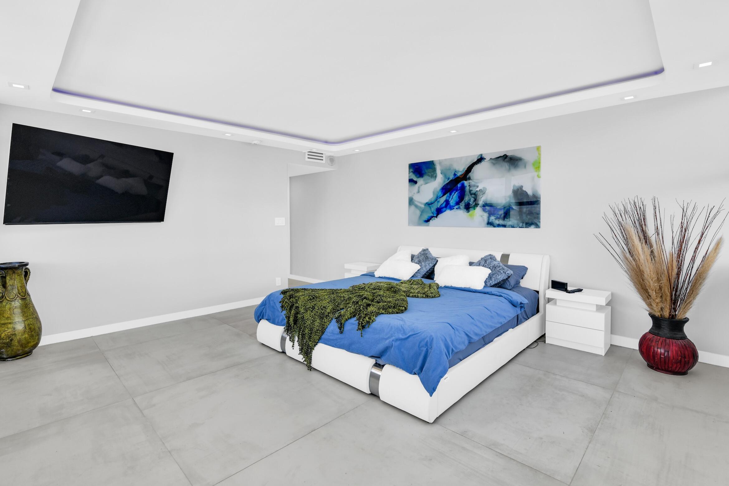2000 South Ocean Boulevard, Unit 6K Boca Raton, FL 33432 - Photo 24 of 93 a spacious bedroom with a bed and a flat screen tv