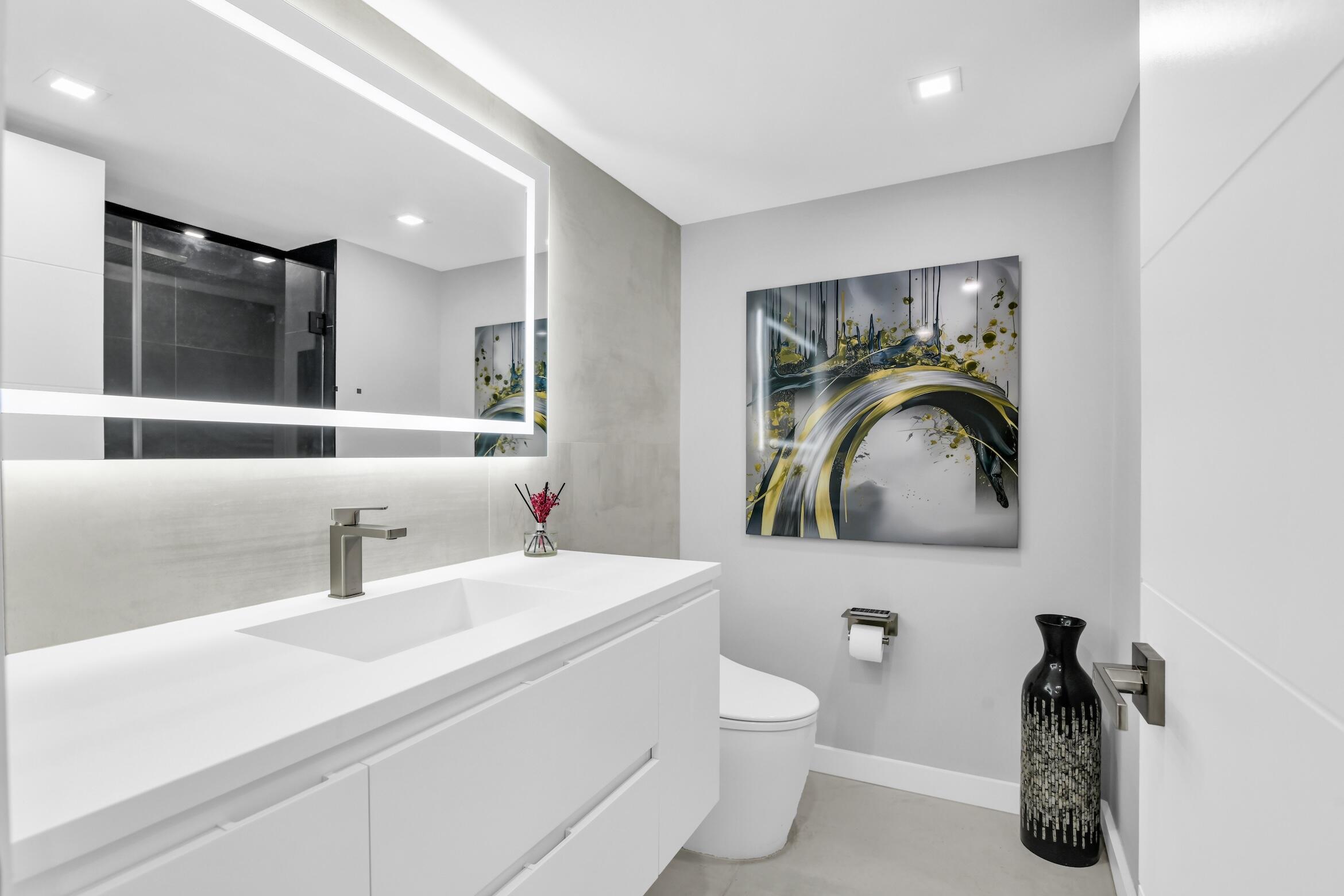 2000 South Ocean Boulevard, Unit 6K Boca Raton, FL 33432 - Photo 31 of 93 a bathroom with a toilet sink and mirror