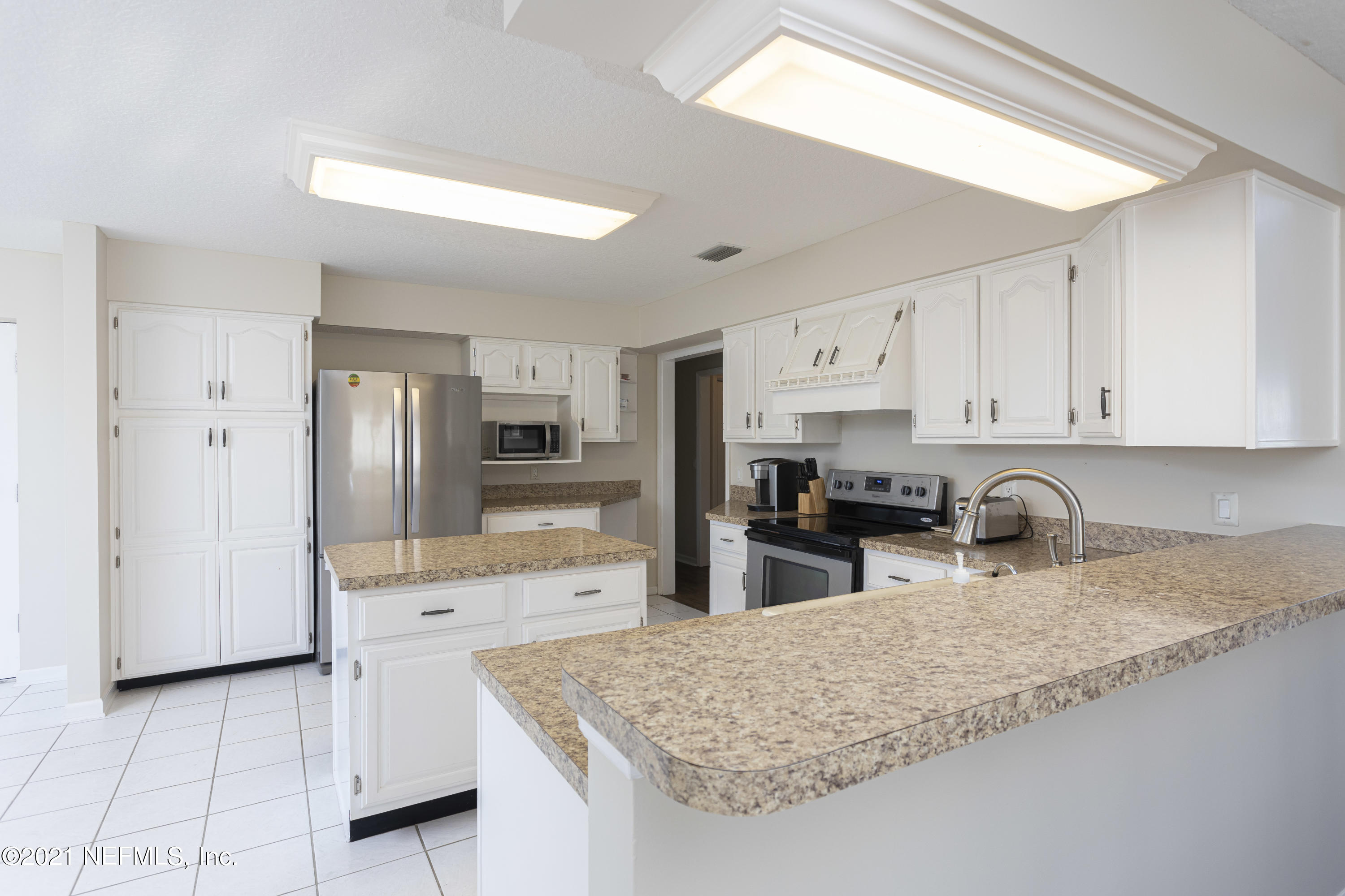 6348 Salado Road St. Augustine, FL 32080 - Photo 13 of 48 a kitchen with stainless steel appliances granite countertop a sink refrigerator and cabinets