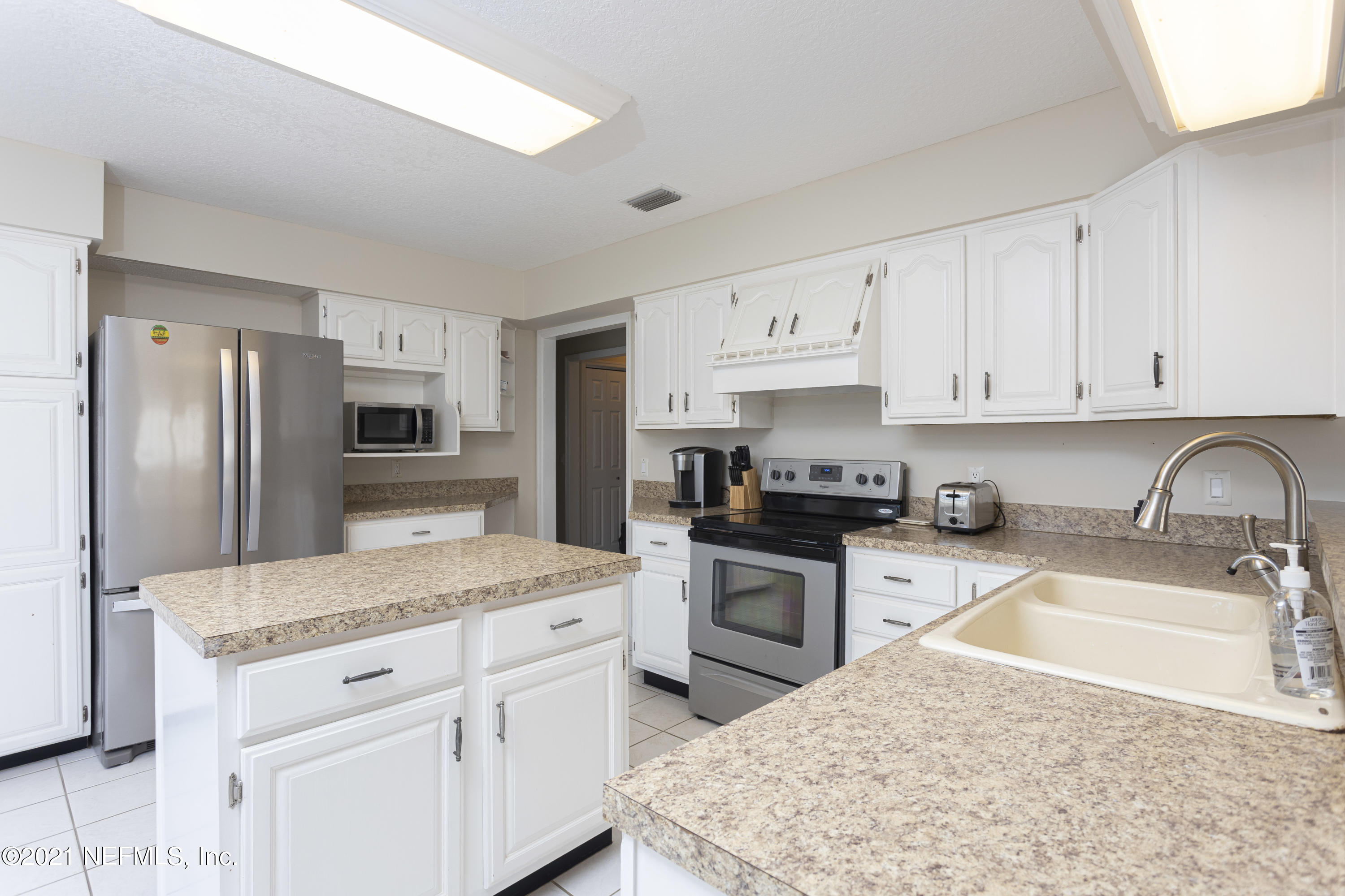 6348 Salado Road St. Augustine, FL 32080 - Photo 14 of 48 a kitchen with stainless steel appliances granite countertop a sink stove refrigerator and granite counter tops
