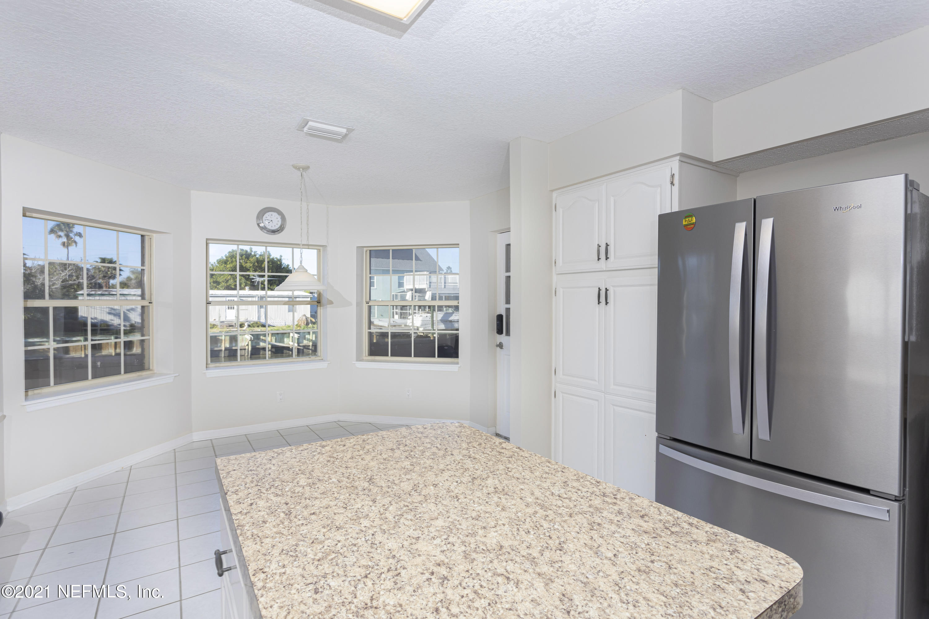 6348 Salado Road St. Augustine, FL 32080 - Photo 17 of 48 a view of a kitchen with wooden floor and a refrigerator