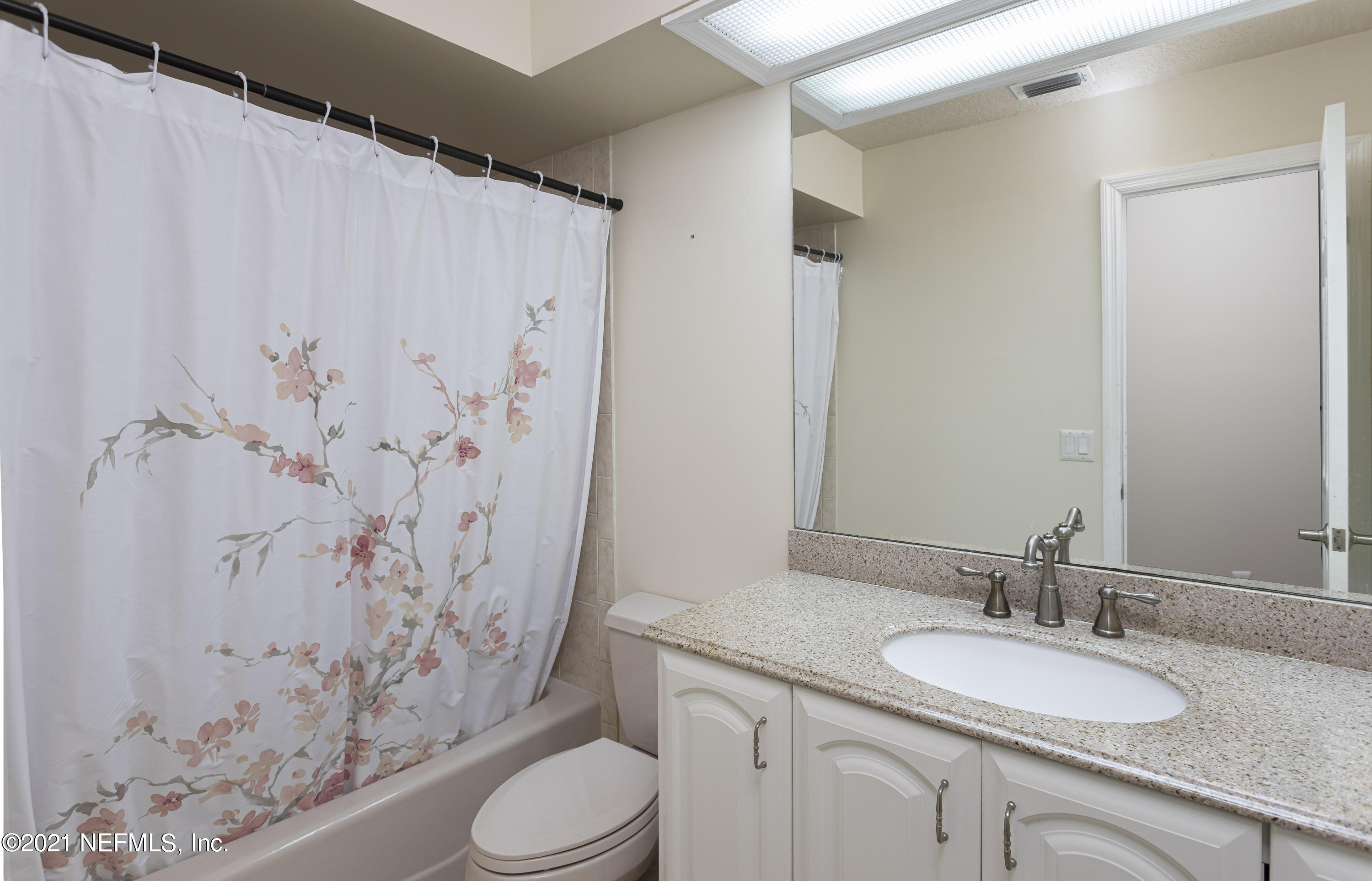 6348 Salado Road St. Augustine, FL 32080 - Photo 28 of 48 a bathroom with a granite countertop sink toilet and a mirror
