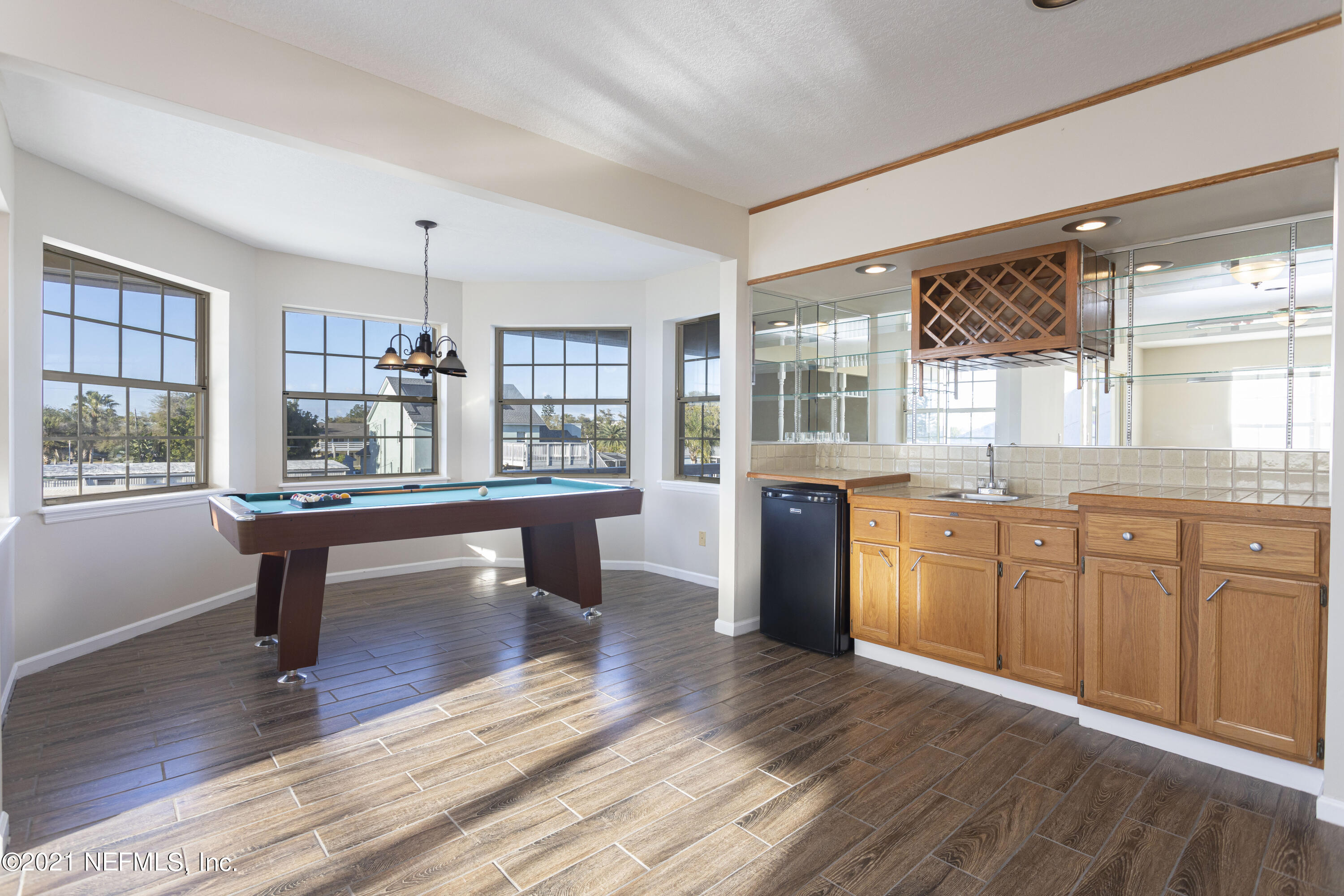 6348 Salado Road St. Augustine, FL 32080 - Photo 32 of 48 a kitchen with stainless steel appliances granite countertop wooden floors and white cabinets