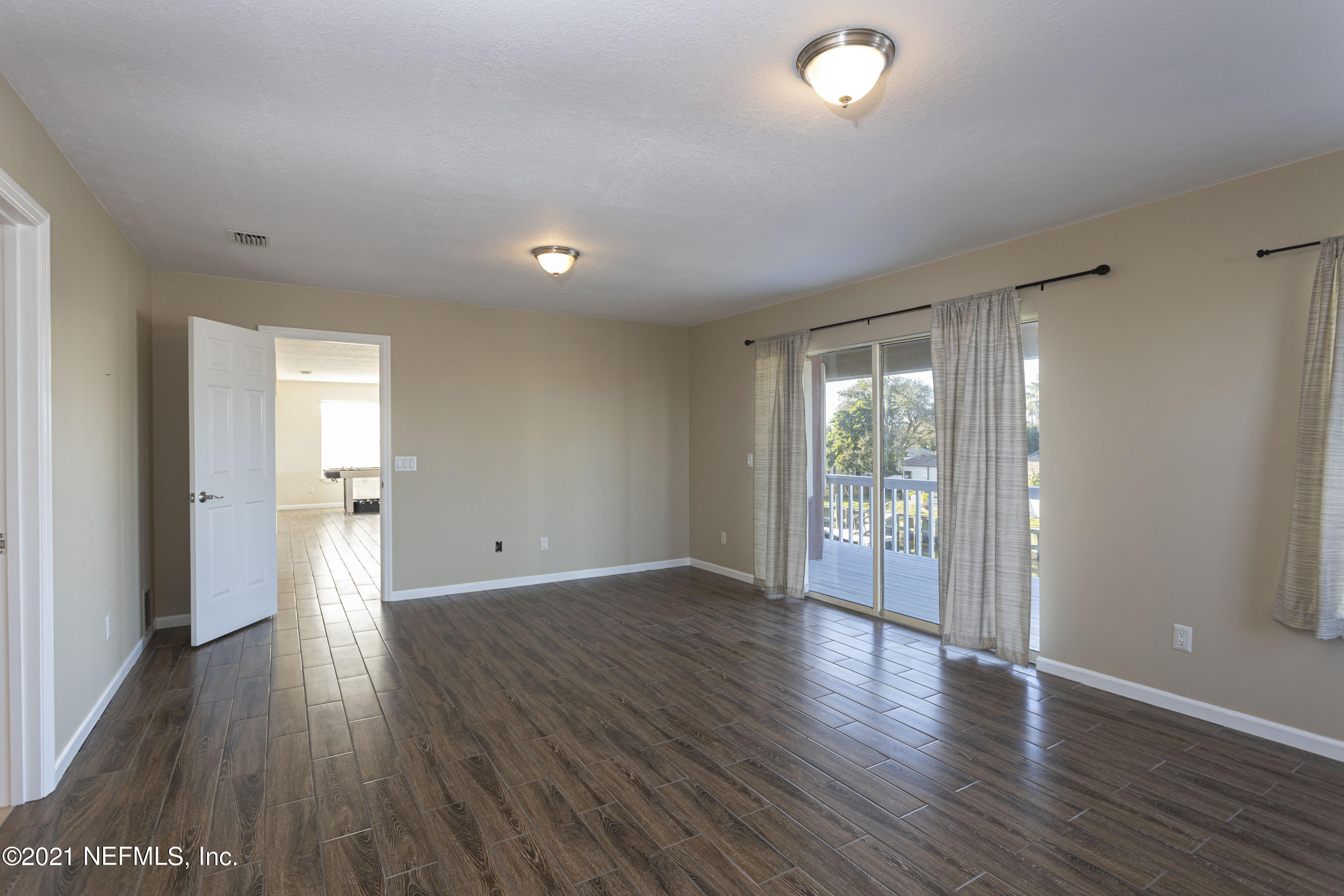 6348 Salado Road St. Augustine, FL 32080 - Photo 33 of 48 a view of an empty room with wooden floor and a window