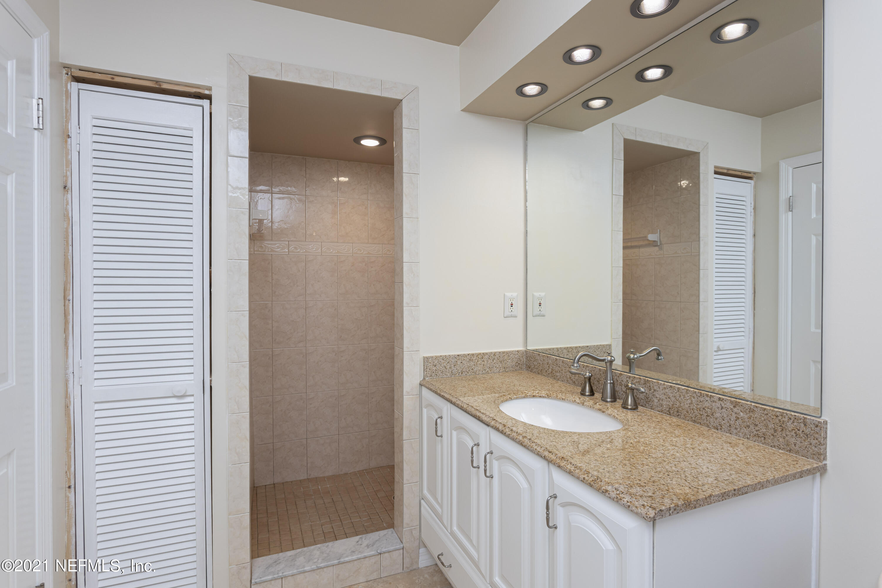 6348 Salado Road St. Augustine, FL 32080 - Photo 34 of 48 a bathroom with a granite countertop sink and a mirror