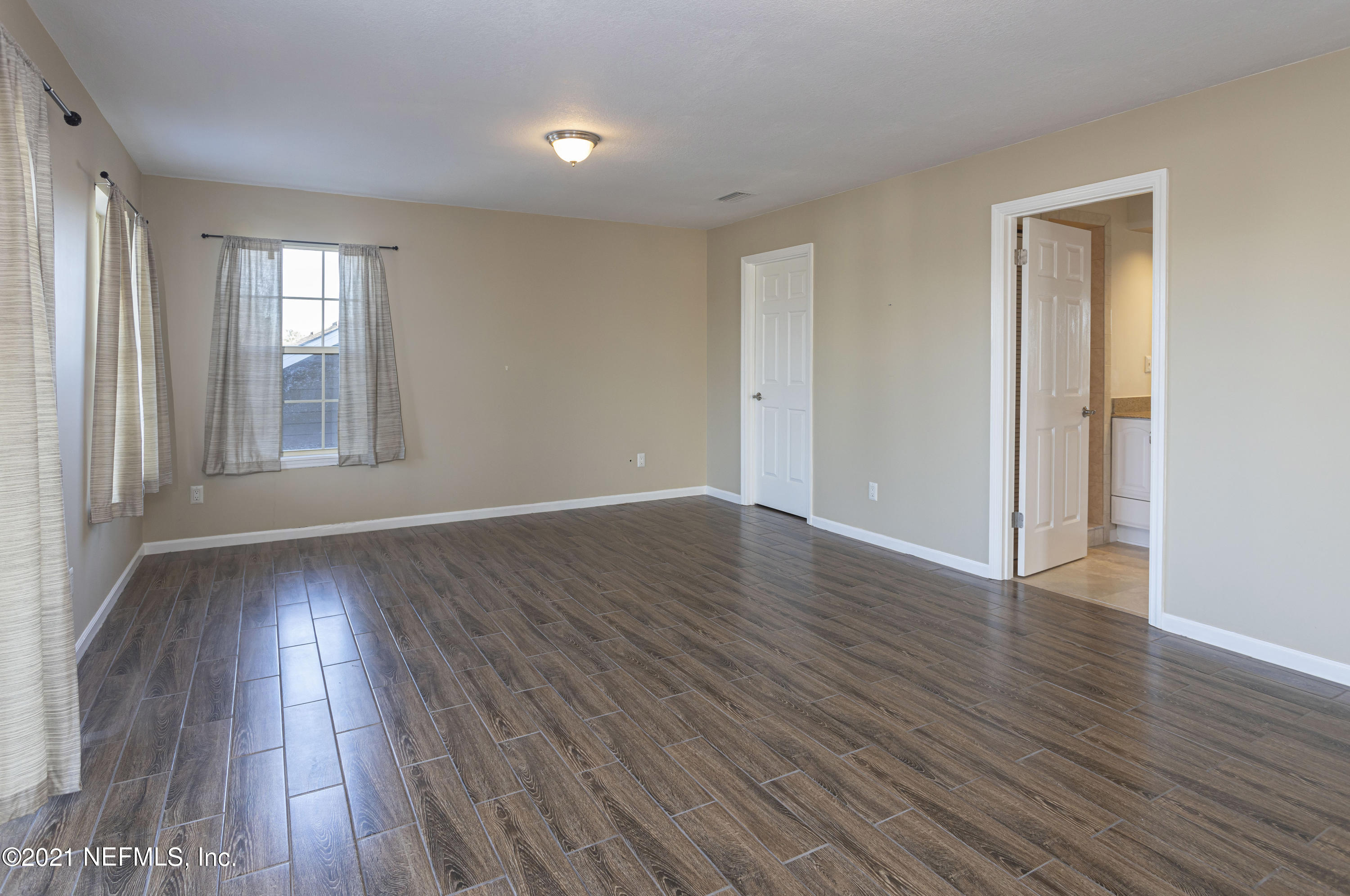 6348 Salado Road St. Augustine, FL 32080 - Photo 37 of 48 a view of an empty room with wooden floor and a window