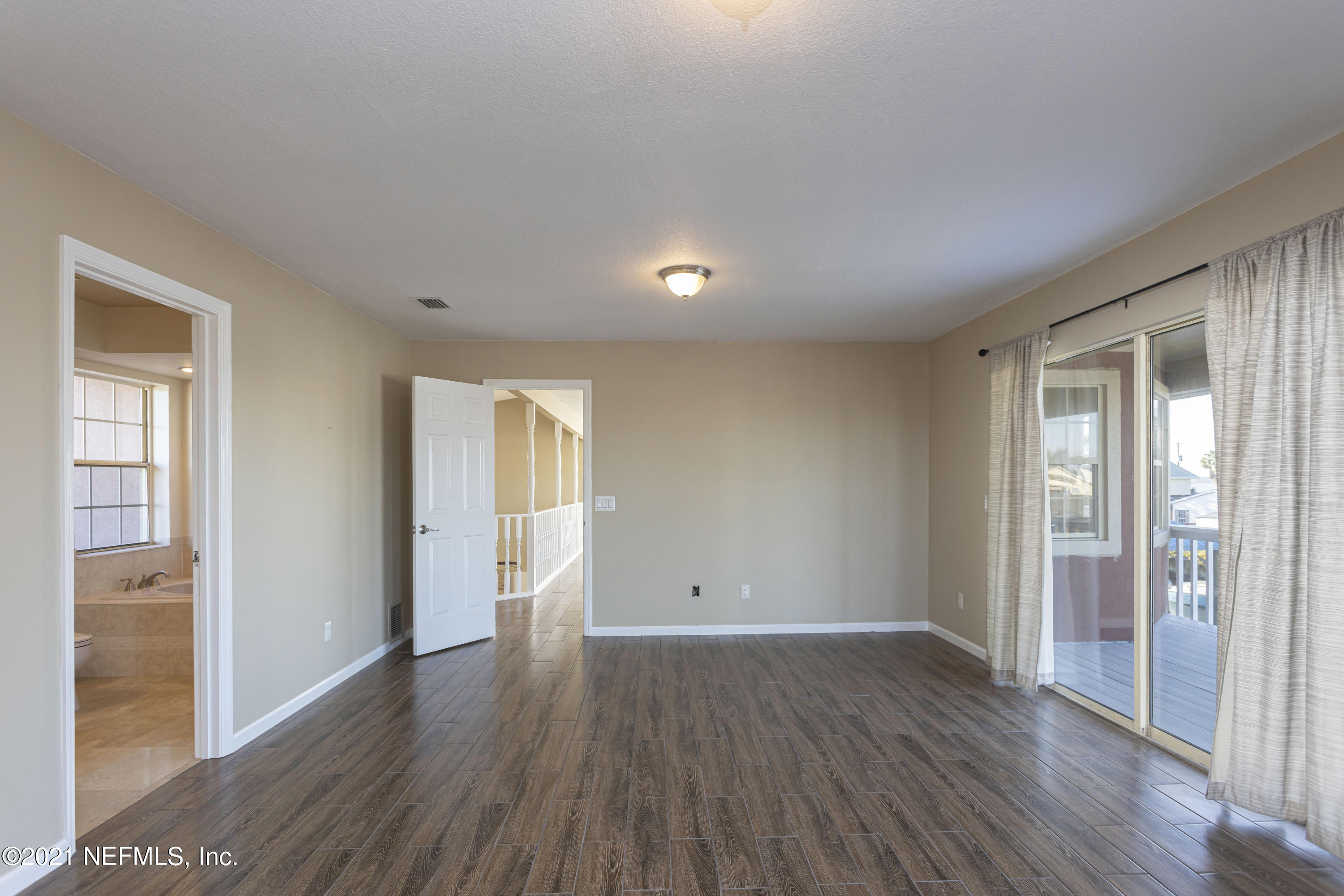 6348 Salado Road St. Augustine, FL 32080 - Photo 38 of 48 wooden floor in an empty room with a window