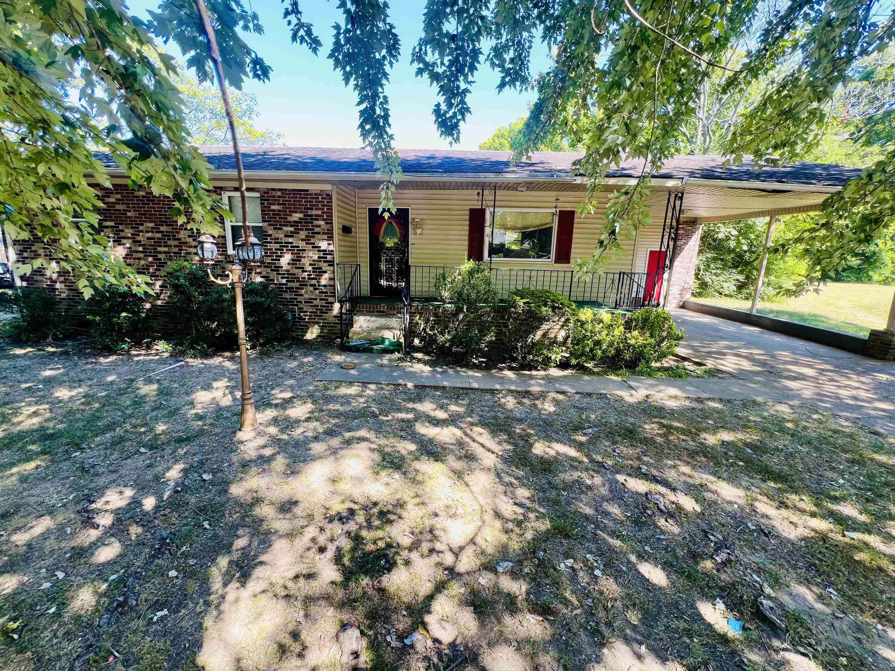 900 Peete Street Covington, TN 38019 - Photo 2 of 6 a view of a house with a small yard and a large tree