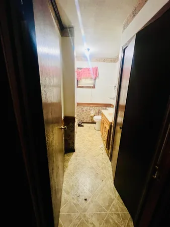a bathroom with a sink and mirror with toilet