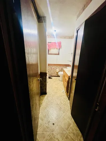 a bathroom with a sink and mirror with toilet