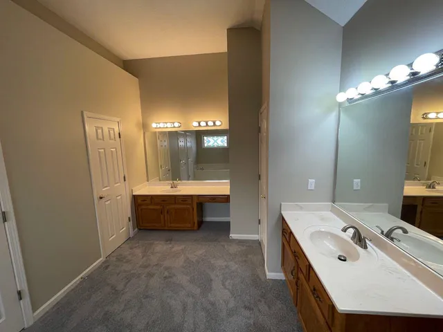 a bathroom with a tub sink and mirror