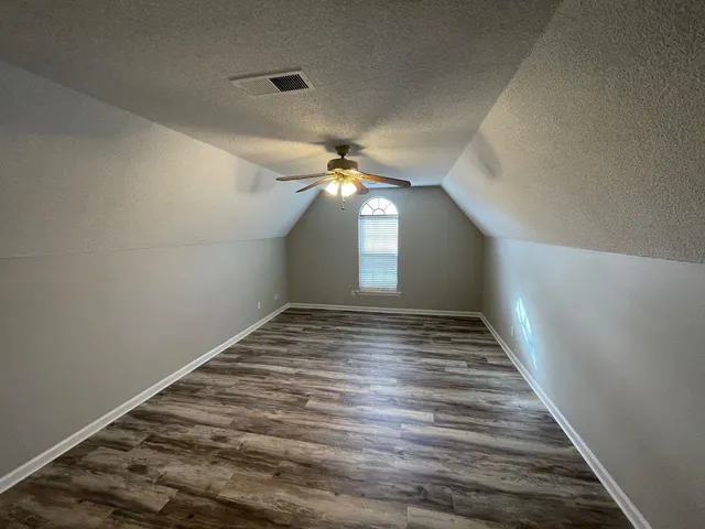 a view of a hallway to a house with stairs