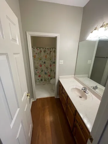 a bathroom with a toilet and a shower curtain