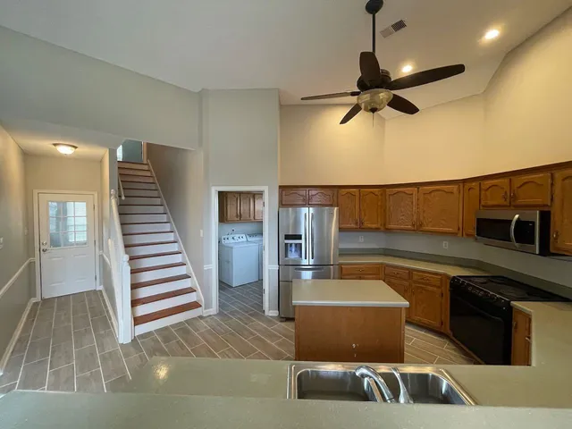 a kitchen with a sink and a refrigerator