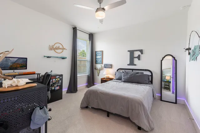 a bathroom with a bathtub sink vanity mirror and toilet