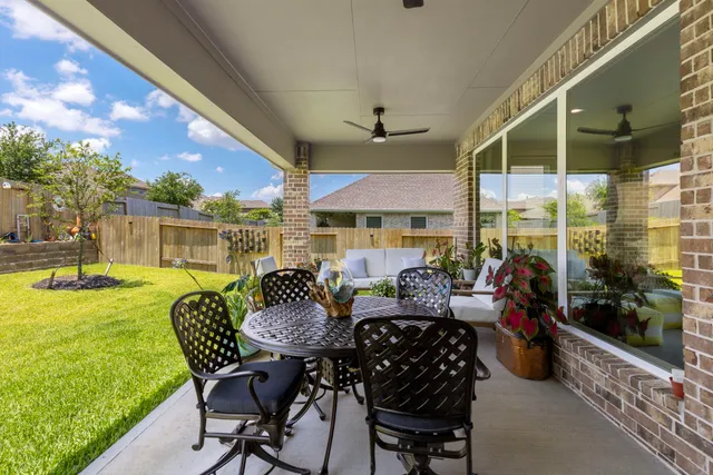 a view of a patio with couches chairs and swimming pool