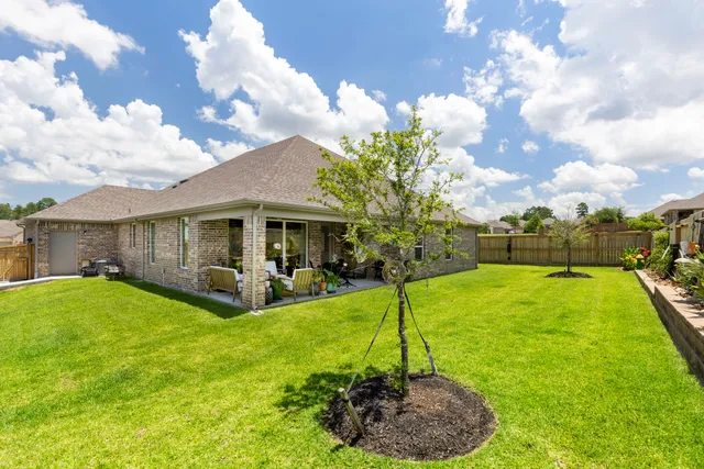 a view of a house with a backyard porch and sitting area