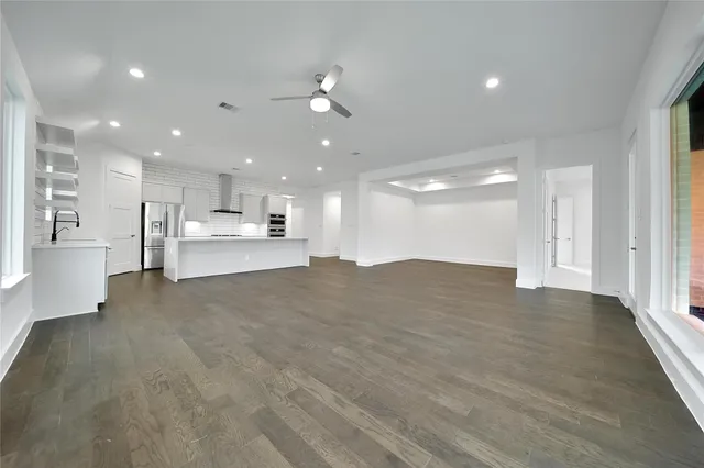 a view of kitchen with kitchen island white cabinets and wooden floor