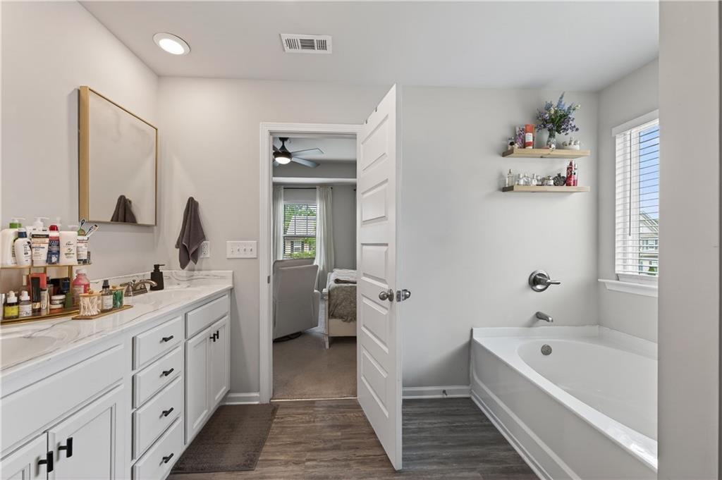266 Shoals Bridge Road Acworth, GA 30102 - Photo 25 of 43 a spacious bathroom with a double vanity sink a mirror and a bathtub