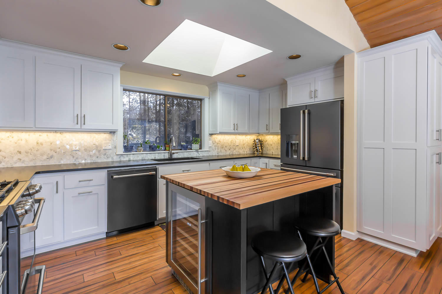 17704 Rogue Lane Sunriver, OR 97707 - Photo 12 of 26 a kitchen with stainless steel appliances granite countertop a stove a refrigerator and a sink with wooden cabinets