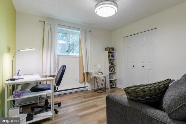 a view of a livingroom with workspace and a window
