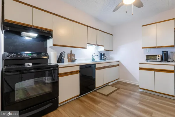 a kitchen with stainless steel appliances a stove a sink and a microwave
