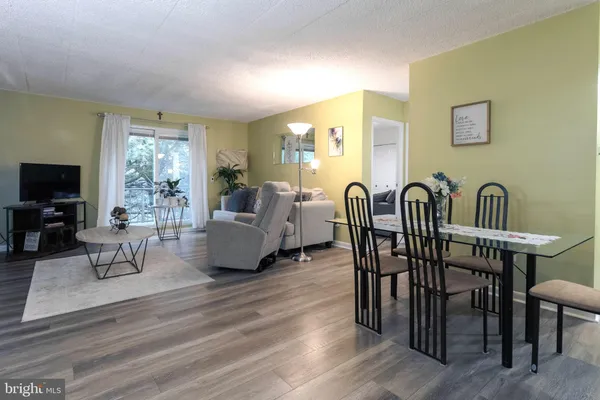 a living room with furniture a flat screen tv and a large window