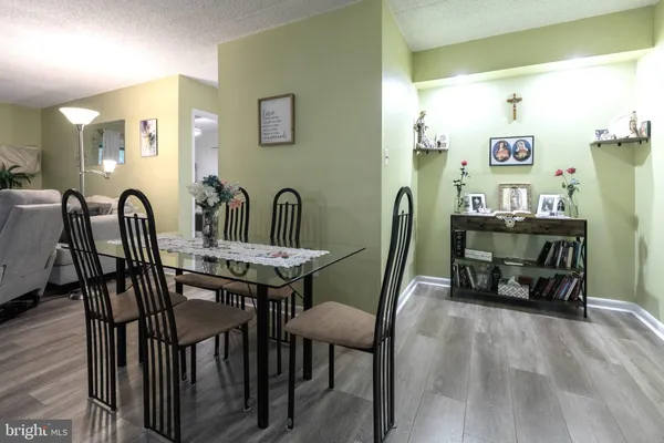 a view of a a dining room with furniture and wooden floor