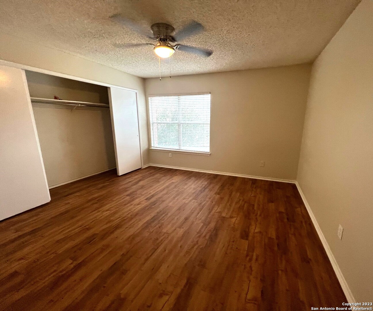 8615 Cross Spring San Antonio, TX 78251 - Photo 12 of 15 wooden floor in an empty room with a window
