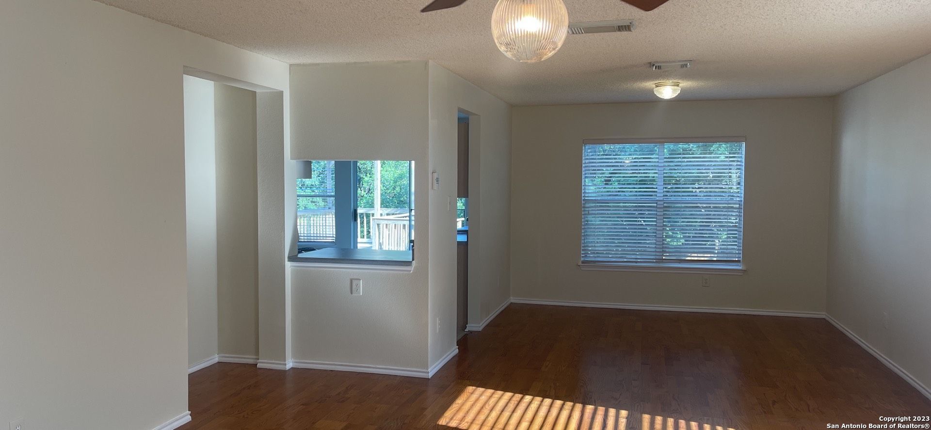 8615 Cross Spring San Antonio, TX 78251 - Photo 3 of 15 a view of an empty room with wooden floor and a window