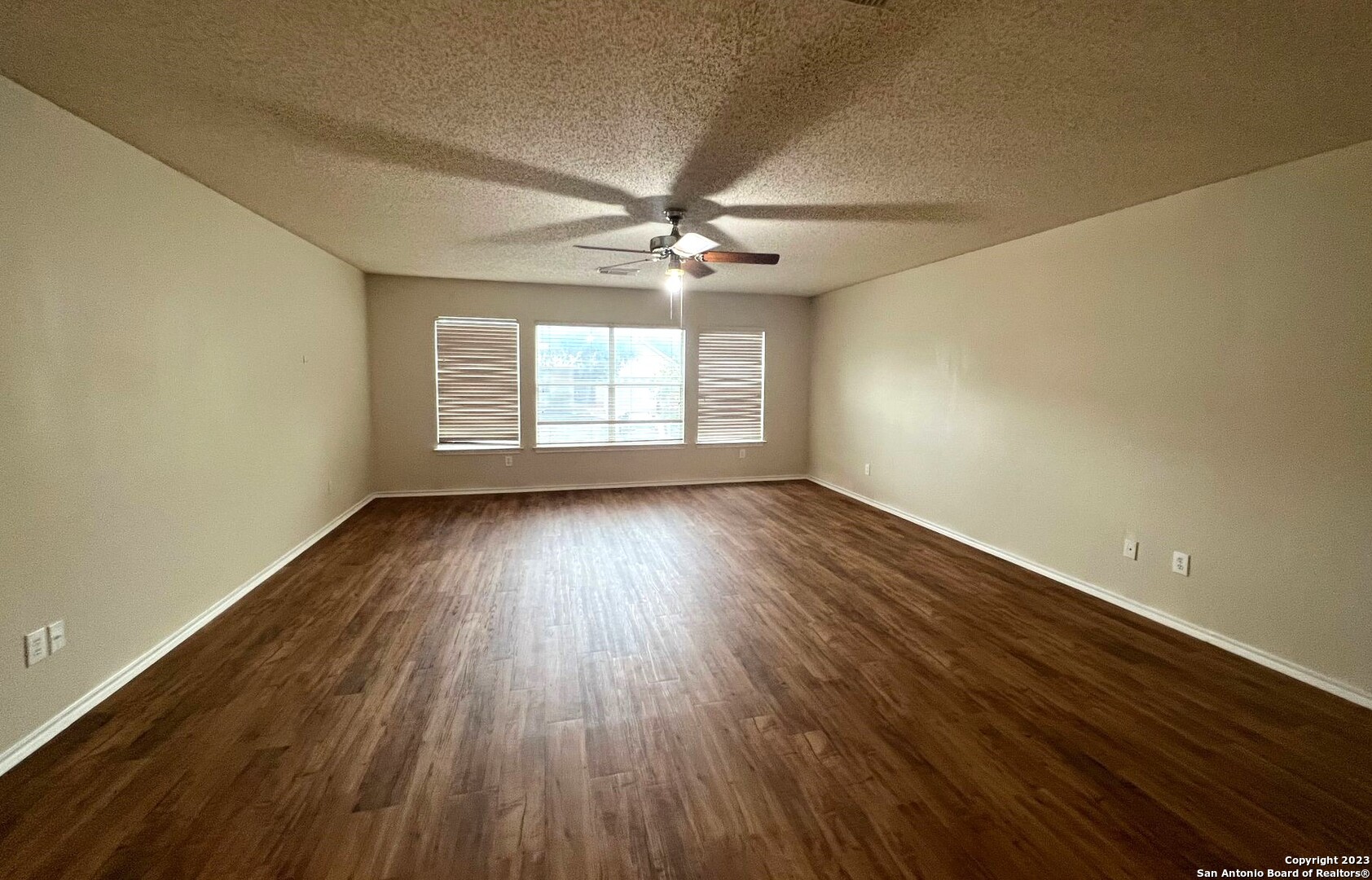8615 Cross Spring San Antonio, TX 78251 - Photo 7 of 15 wooden floor in an empty room with a window